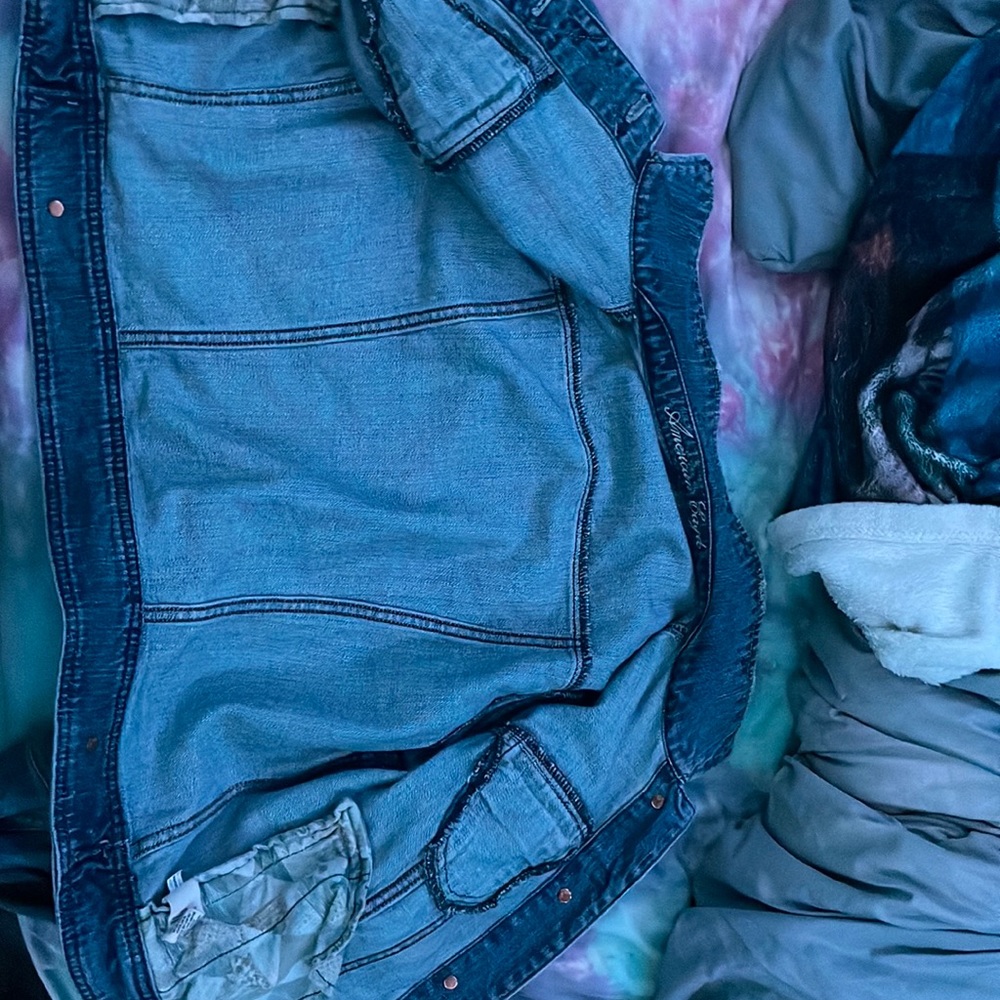Jean jacket long sleeve with buttons and worn a good amount